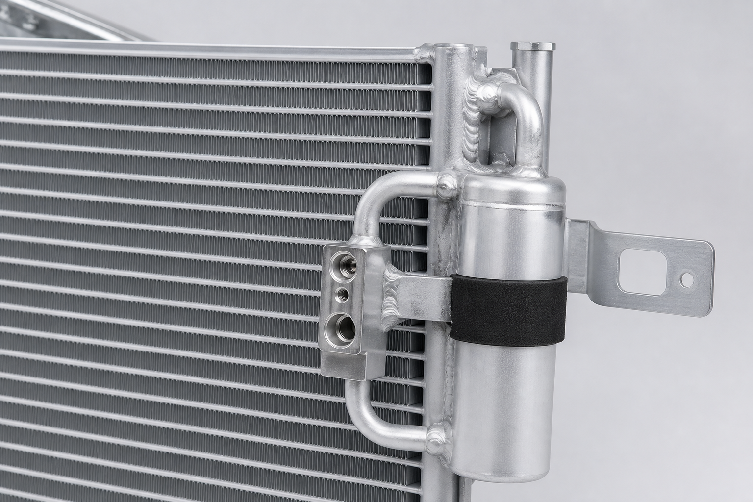 Close-up of automotive parallel-flow A/C condenser microchannel core and receiver drier