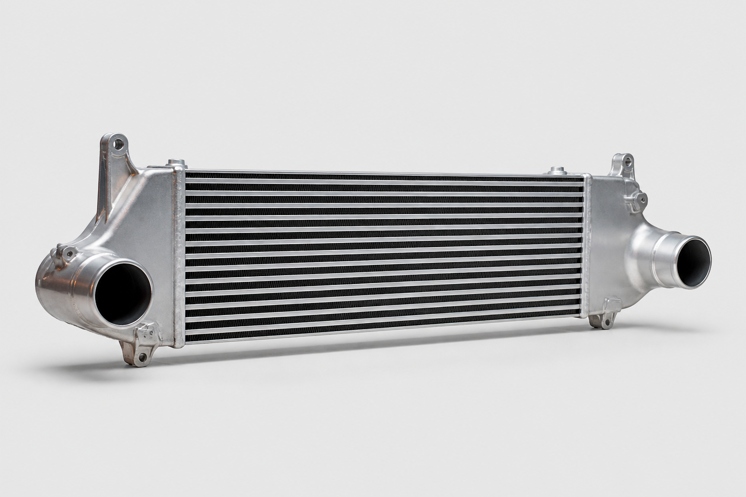 Aluminum automotive intercooler with cast end tanks